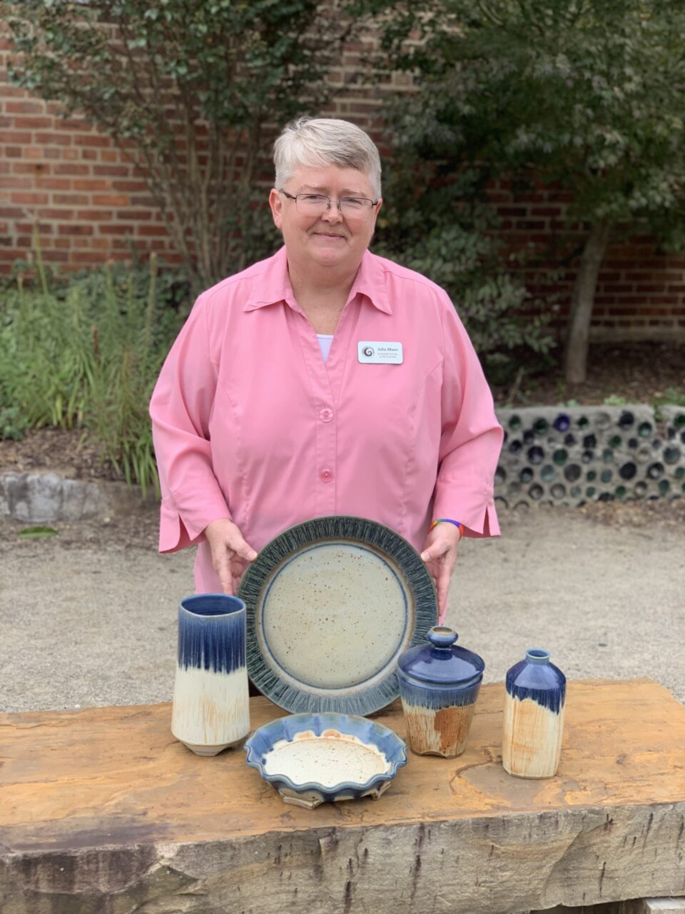 Julia Mann with finished pots grouping, blue texture and mama glaze