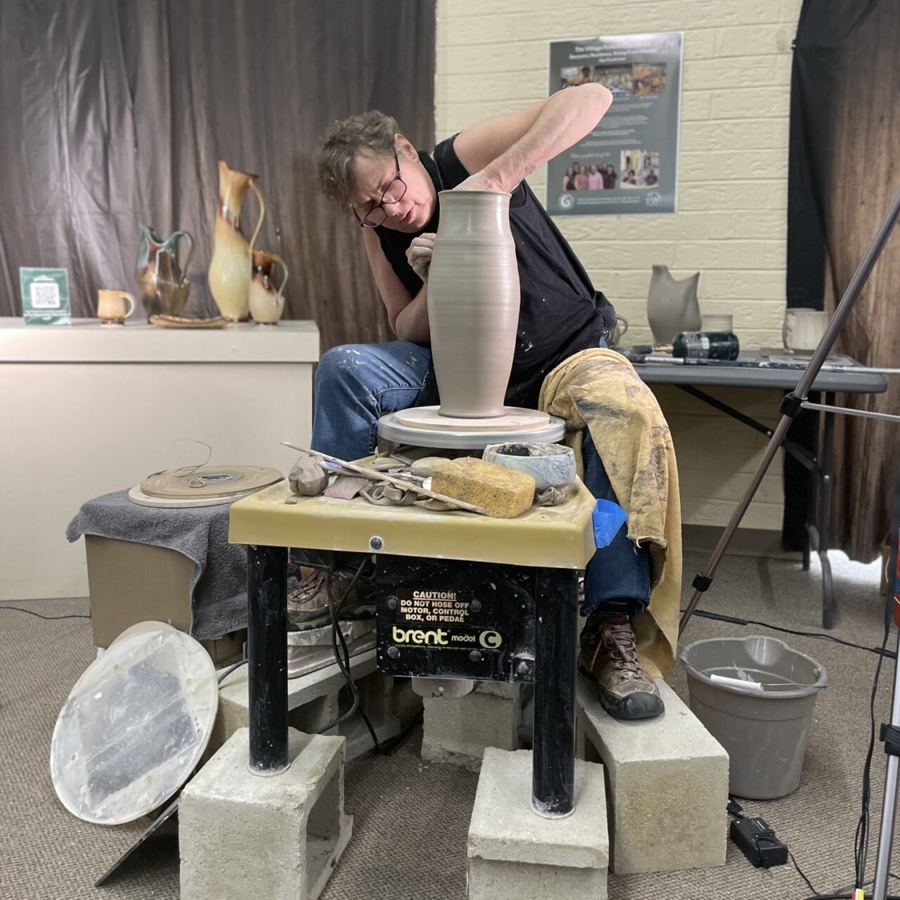 Sarah Wells Rolland throwing on potters wheel on workshop tour, demonstrating