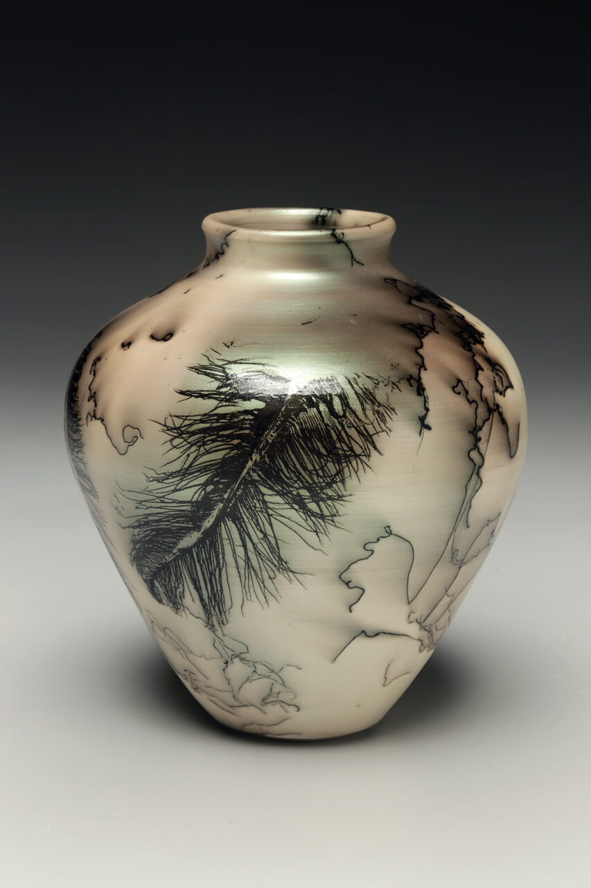 Judi Harwood finished pot, green mica and horsehair raku pot, feather