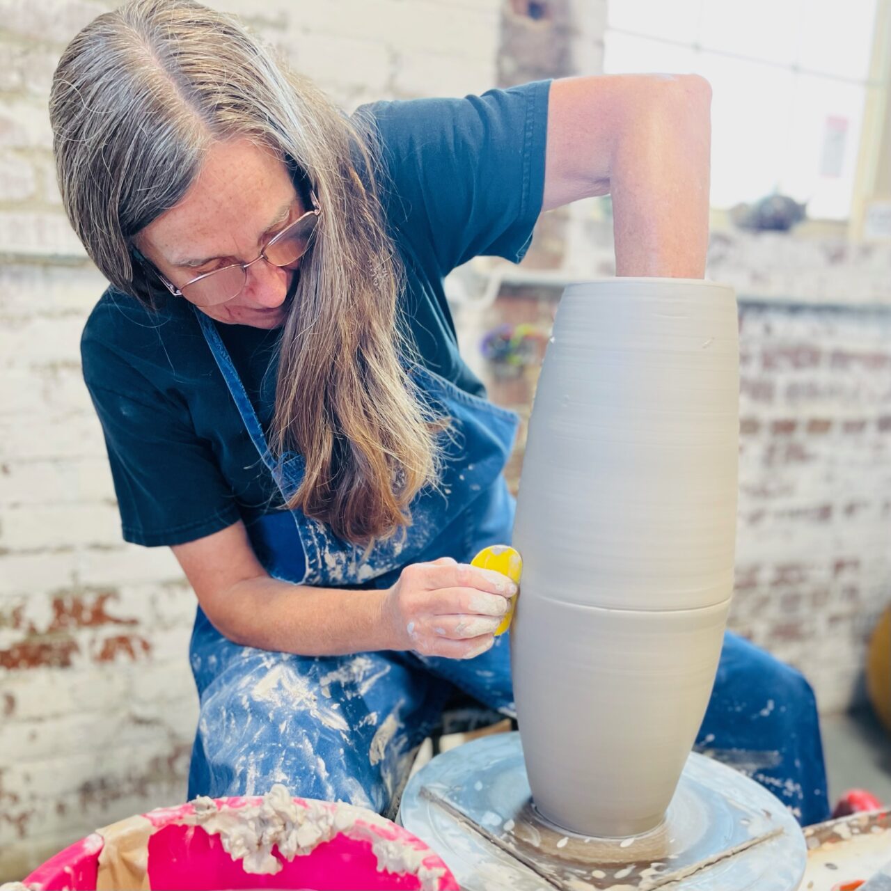 Judi Harwood throwing on the potters wheel, joining seam of sectional pot