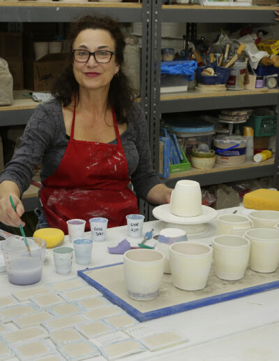 Tracey Hawkins testing glazes or surface design in community ISM Studio