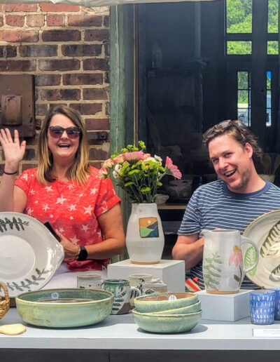 Shapes of Summer show, ISM participant show, Missy Henry and Chad Caldwell at their booth, Independent Study and Mentoring Advanced Studies Program, cropped