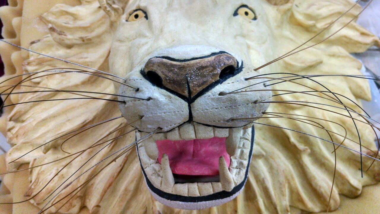 Close up features of Judi Harwood finished lion's head bust sculpture, wall mounted