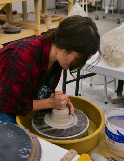 Hannah Barry ISM student throwing at potters wheel