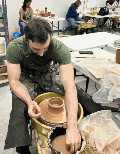 Teaching Center student, Man working on pottery wheel